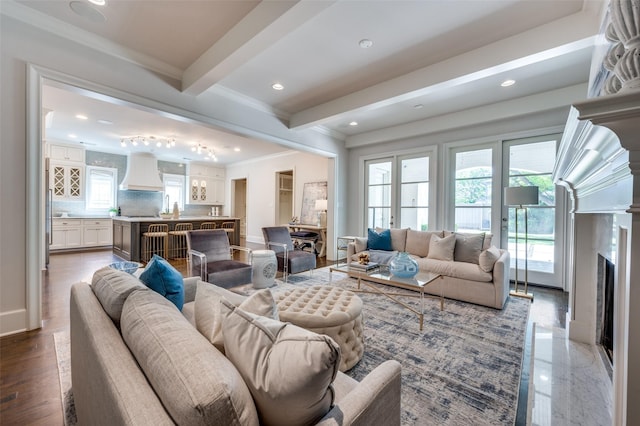 living room featuring beam ceiling, crown molding, a high end fireplace, and recessed lighting