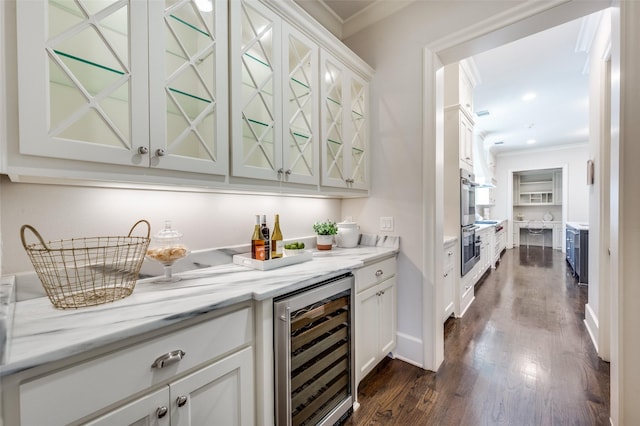 indoor dry bar featuring beverage cooler, ornamental molding, and dark wood-style floors