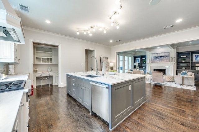 kitchen with dishwasher, gray cabinets, a sink, wall chimney range hood, and crown molding