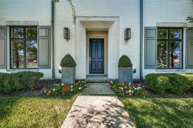 doorway to property featuring brick siding