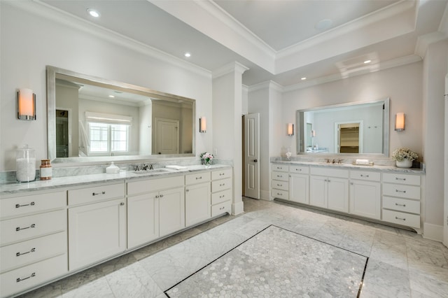 full bath featuring marble look tile flooring, ornamental molding, recessed lighting, two vanities, and a tray ceiling