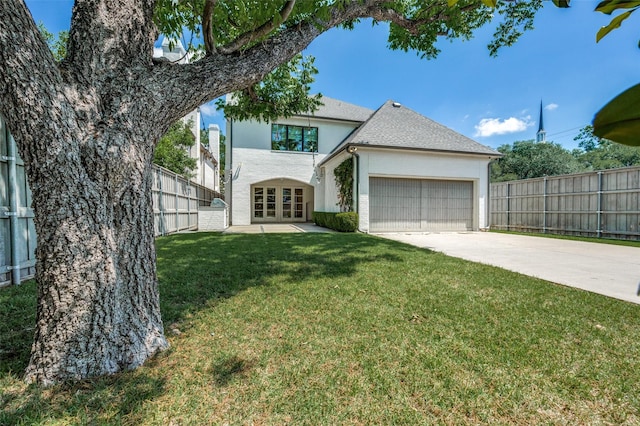 view of front of property featuring french doors, an attached garage, stucco siding, and concrete driveway
