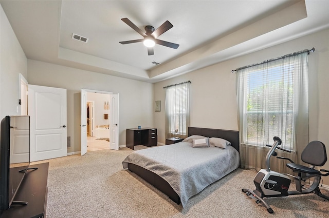 4624 Southpointe Dr, Richardson, TX 75082 - carpeted bedroom featuring a tray ceiling, multiple windows, baseboards, and ensuite bathroom