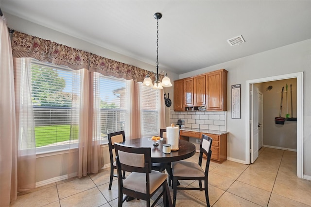 4624 Southpointe Dr, Richardson, TX 75082 - dining room featuring healthy amount of natural light, a chandelier, baseboards, and light tile patterned floors