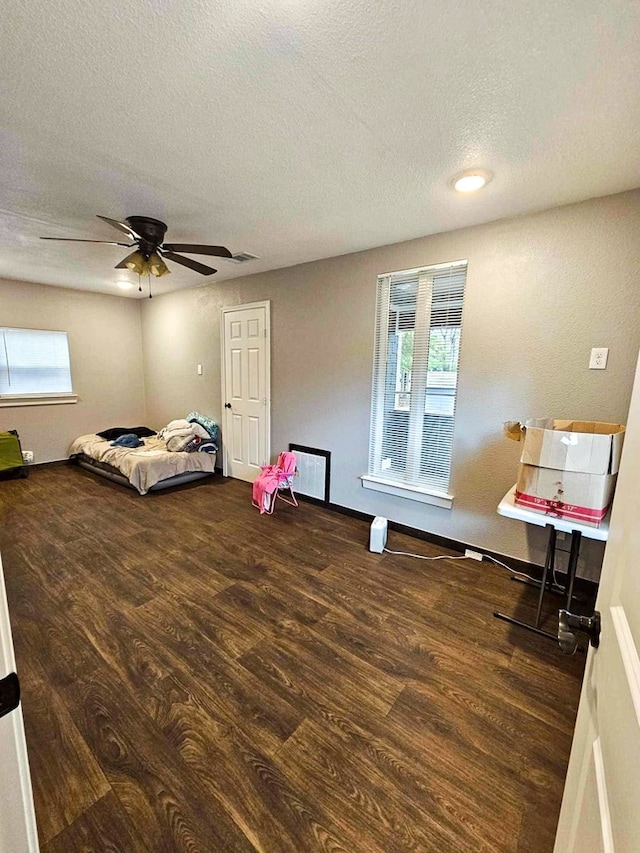 325 Fcr 1211, Fairfield, TX 75840 - bedroom featuring wood finished floors, multiple windows, a textured ceiling, ceiling fan, and baseboards