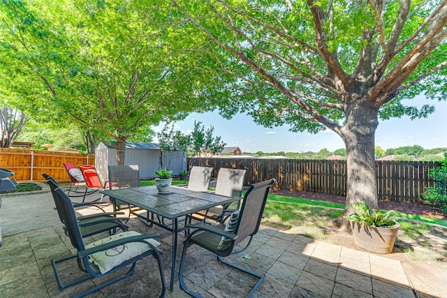 2505 Hillary Trl, Mansfield, TX 76063 - view of patio / terrace featuring a storage shed, outdoor dining space, and a fenced backyard