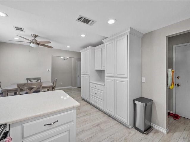 1008 Breezewood Dr, Arlington, TX 76017 - kitchen featuring ceiling fan, light countertops, light wood finished floors, white cabinets, and recessed lighting