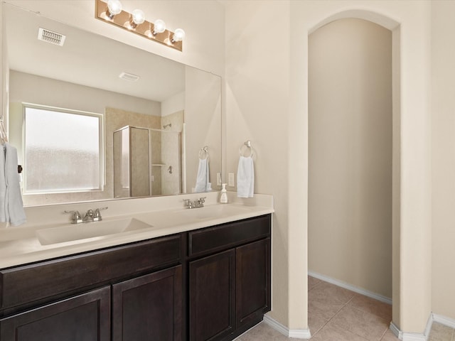 14361 Mariposa Lily Ln, Fort Worth, TX 76052 - full bathroom with a shower stall, double vanity, tile patterned floors, and baseboards