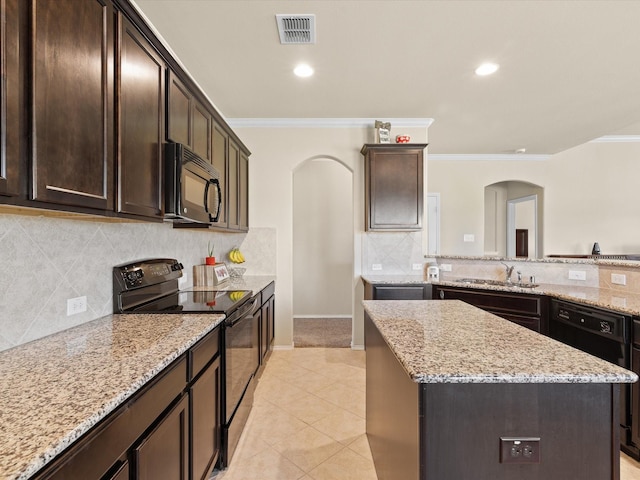 14361 Mariposa Lily Ln, Fort Worth, TX 76052 - kitchen featuring black appliances, crown molding, a kitchen island, arched walkways, and dark brown cabinetry