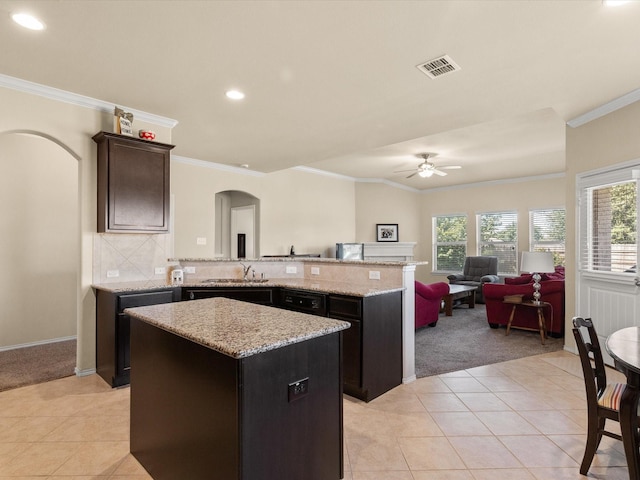 14361 Mariposa Lily Ln, Fort Worth, TX 76052 - kitchen with light carpet, ornamental molding, a ceiling fan, light tile patterned flooring, and arched walkways