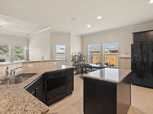 14361 Mariposa Lily Ln, Fort Worth, TX 76052 - kitchen with black appliances, a sink, light tile patterned flooring, crown molding, and light stone counters