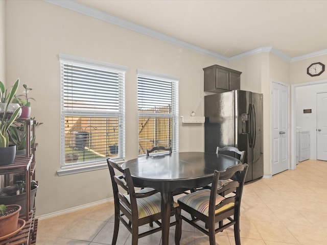 14361 Mariposa Lily Ln, Fort Worth, TX 76052 - dining space featuring washer / clothes dryer, light tile patterned floors, crown molding, plenty of natural light, and baseboards