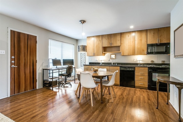 4616 W Lovers Ln Unit 231, Dallas, TX 75209 - kitchen featuring black appliances, dark countertops, dark wood-style flooring, and decorative light fixtures