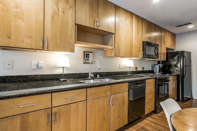 4616 W Lovers Ln Unit 231, Dallas, TX 75209 - kitchen featuring black appliances, a sink, dark wood-style flooring, dark stone countertops, and recessed lighting