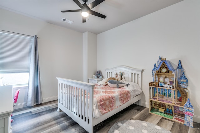 bedroom featuring wood finished floors, ceiling fan, and baseboards