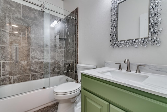 bathroom featuring toilet, vanity, and shower / bath combination with glass door
