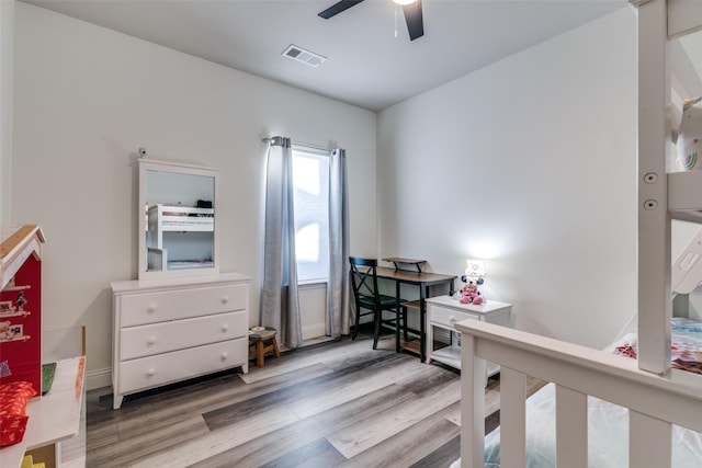 home office with a ceiling fan, wood finished floors, and baseboards