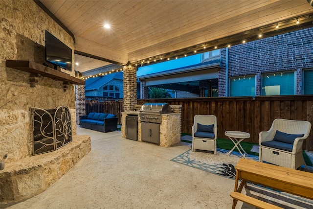 view of patio / terrace with an outdoor kitchen, a grill, fence, and outdoor lounge area