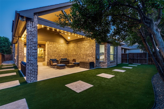 rear view of property with brick siding, a patio area, and an outdoor hangout area
