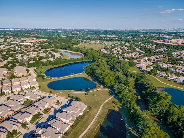 aerial view of property's location with a large body of water and nearby suburban area