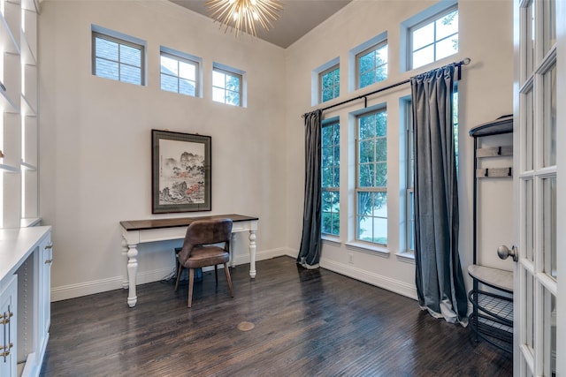 office featuring dark wood finished floors, plenty of natural light, baseboards, crown molding, and a towering ceiling