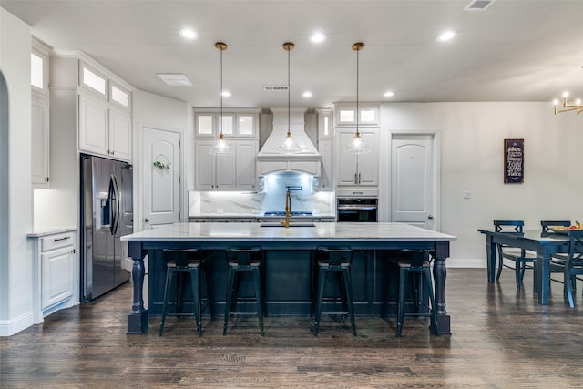 kitchen featuring appliances with stainless steel finishes, custom range hood, white cabinets, dark wood-style flooring, and recessed lighting