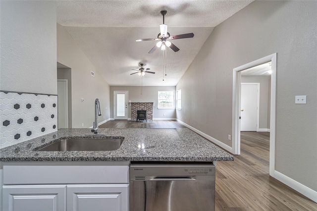 3809 Glengate Dr, Arlington, TX 76016 - kitchen with dishwasher, a sink, vaulted ceiling, a textured ceiling, and ceiling fan