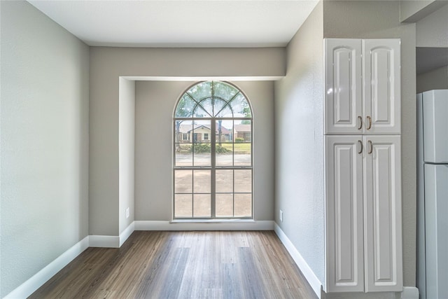 3809 Glengate Dr, Arlington, TX 76016 - unfurnished dining area with wood finished floors and baseboards