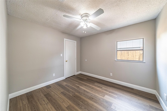 3809 Glengate Dr, Arlington, TX 76016 - spare room featuring baseboards, dark wood-style floors, a textured ceiling, and a ceiling fan