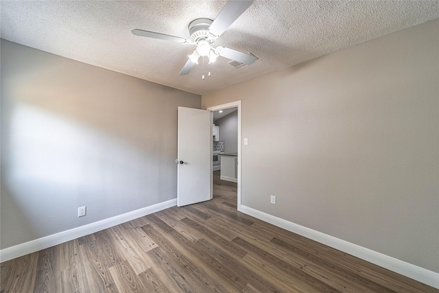 3809 Glengate Dr, Arlington, TX 76016 - unfurnished room featuring ceiling fan, baseboards, dark wood-style floors, and a textured ceiling