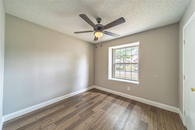 3809 Glengate Dr, Arlington, TX 76016 - empty room with baseboards, a ceiling fan, dark wood finished floors, and a textured ceiling