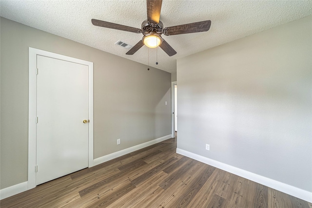 3809 Glengate Dr, Arlington, TX 76016 - unfurnished bedroom featuring wood finished floors, baseboards, a textured ceiling, and a ceiling fan