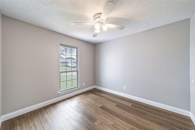 3809 Glengate Dr, Arlington, TX 76016 - empty room featuring dark wood-style floors, baseboards, a ceiling fan, and a textured ceiling