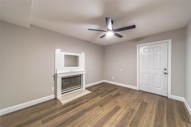 3809 Glengate Dr, Arlington, TX 76016 - unfurnished living room featuring ceiling fan, baseboards, dark wood-type flooring, and a fireplace with flush hearth