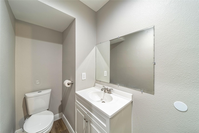 3809 Glengate Dr, Arlington, TX 76016 - half bathroom with vanity, toilet, and wood finished floors