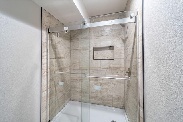3809 Glengate Dr, Arlington, TX 76016 - bathroom with a textured wall and a stall shower