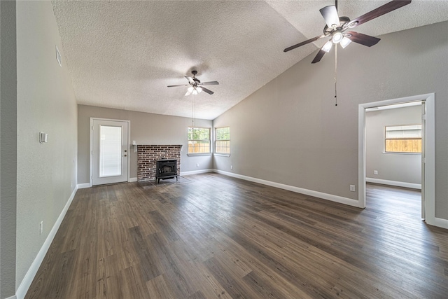 3809 Glengate Dr, Arlington, TX 76016 - unfurnished living room with a ceiling fan, a textured ceiling, lofted ceiling, dark wood-type flooring, and baseboards