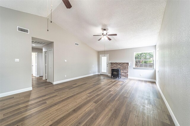 3809 Glengate Dr, Arlington, TX 76016 - unfurnished living room with ceiling fan, a textured ceiling, vaulted ceiling, dark wood-type flooring, and baseboards