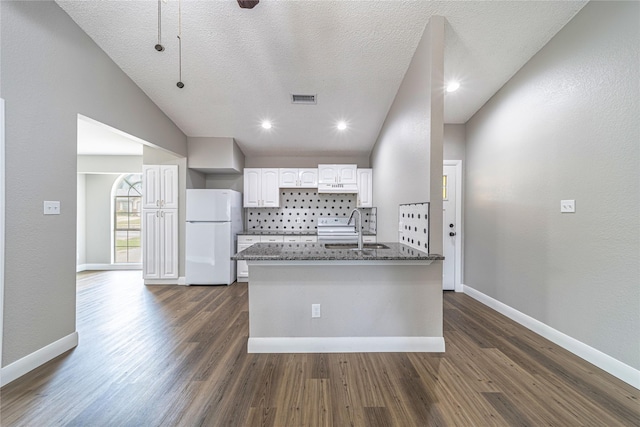 3809 Glengate Dr, Arlington, TX 76016 - kitchen featuring freestanding refrigerator, a sink, white cabinetry, dark stone countertops, and baseboards