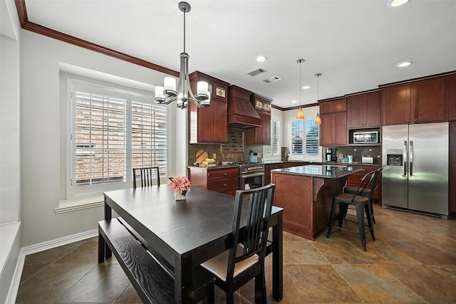 2726 Bandolier Ln, Frisco, TX 75033 - kitchen with appliances with stainless steel finishes, premium range hood, crown molding, a chandelier, and backsplash