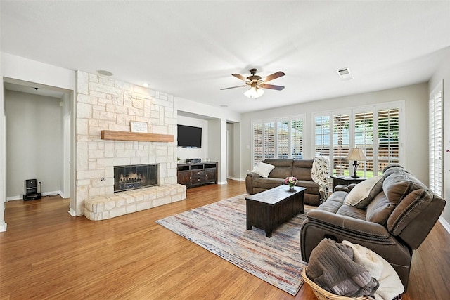 2726 Bandolier Ln, Frisco, TX 75033 - living room with ceiling fan, wood finished floors, and a fireplace