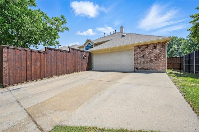 2726 Bandolier Ln, Frisco, TX 75033 - view of side of home with brick siding, a chimney, concrete driveway, a garage, and a shingled roof
