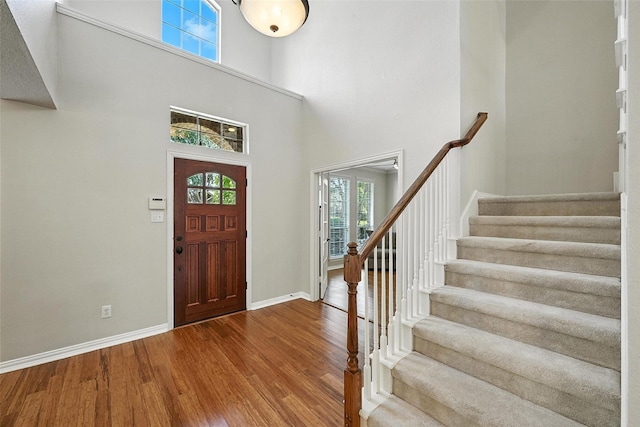 2726 Bandolier Ln, Frisco, TX 75033 - foyer entrance with wood finished floors, plenty of natural light, stairway, and a towering ceiling