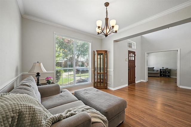 2726 Bandolier Ln, Frisco, TX 75033 - living area featuring a chandelier, ornamental molding, and wood finished floors