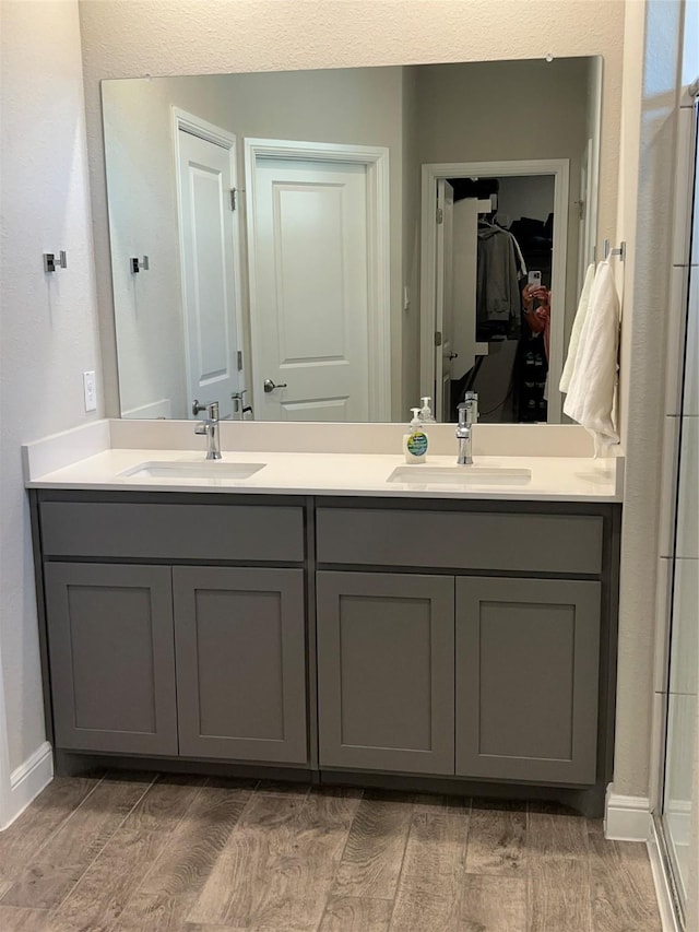 5266 Meadow Ln, Krum, TX 76249 - full bath featuring wood tiled floors, double vanity, baseboards, and a spacious closet