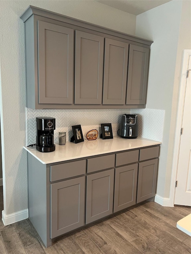 5266 Meadow Ln, Krum, TX 76249 - bar with wood finished floors, baseboards, and backsplash