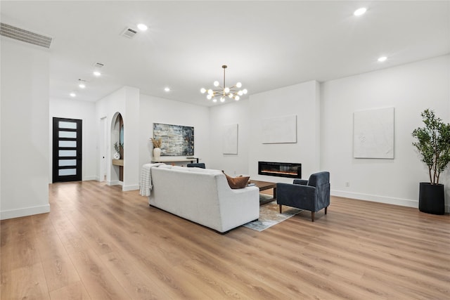 426 Avenue Ave E, Dallas, TX 75203 - living area with a glass covered fireplace, arched walkways, light wood finished floors, recessed lighting, and baseboards