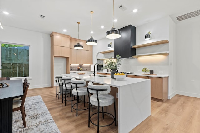 426 Avenue Ave E, Dallas, TX 75203 - kitchen featuring modern cabinets, open shelves, light brown cabinetry, light countertops, and light wood-type flooring