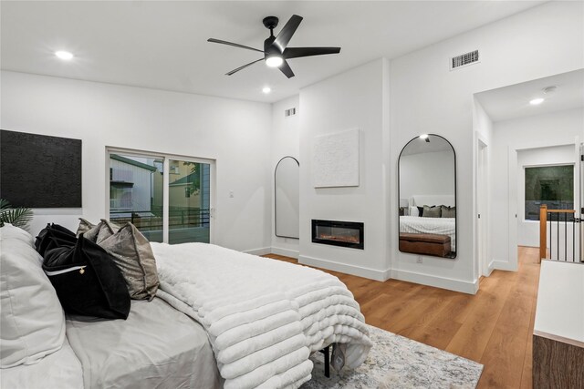 426 Avenue Ave E, Dallas, TX 75203 - bedroom featuring access to exterior, light wood-type flooring, recessed lighting, a glass covered fireplace, and ceiling fan