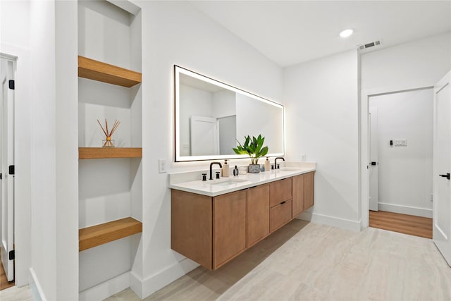426 Avenue Ave E, Dallas, TX 75203 - full bath with wood finished floors, double vanity, baseboards, and recessed lighting